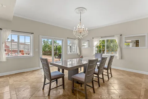 a view of a dining room with furniture and chandelier