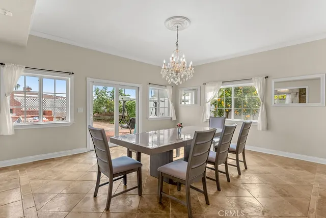 a view of a dining room with furniture and chandelier