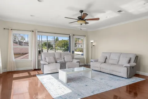 a living room with furniture and a large window with outer view
