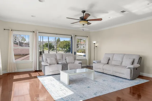 a living room with furniture and a large window with outer view