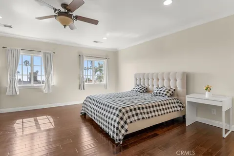 a bedroom with bed and wooden floor