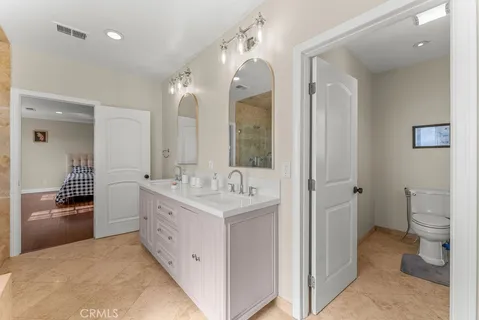 a bathroom with a tub sink and mirror