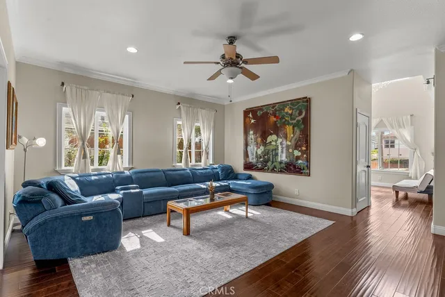 a living room with furniture and wooden floor
