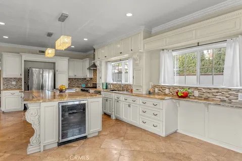 a kitchen with stainless steel appliances a stove a sink dishwasher and cabinets with wooden floor