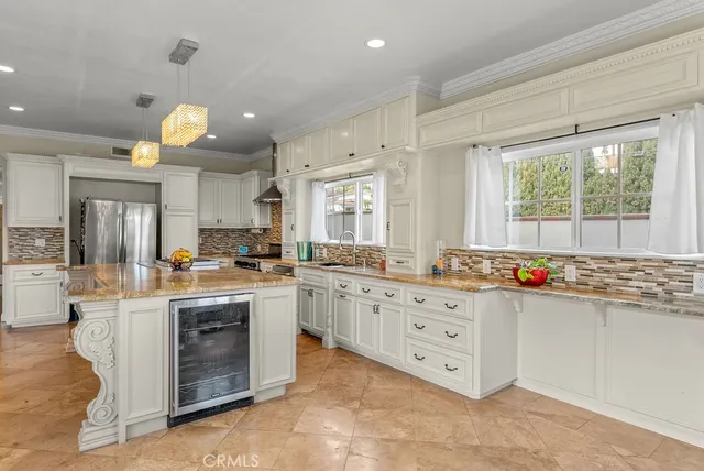 a kitchen with stainless steel appliances a stove a sink dishwasher and cabinets with wooden floor