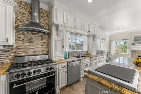 a kitchen with stove and cabinets