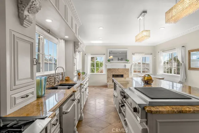 a kitchen with kitchen island a stove a table and chairs in it