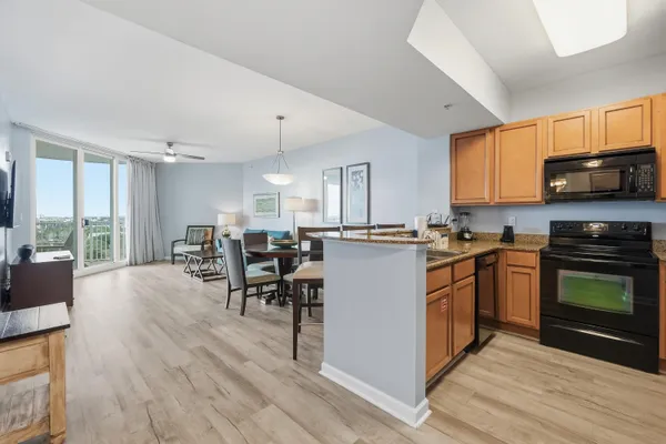 a kitchen with sink cabinets and a stove top oven
