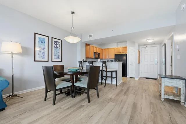 a view of a bedroom with wooden floor and a bed