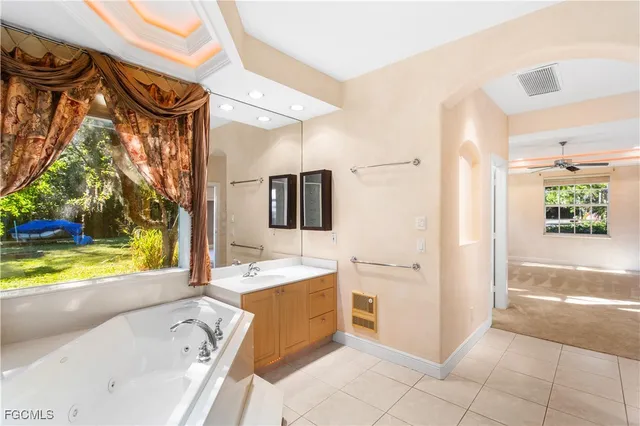 a bathroom with a bathtub sink and a mirror