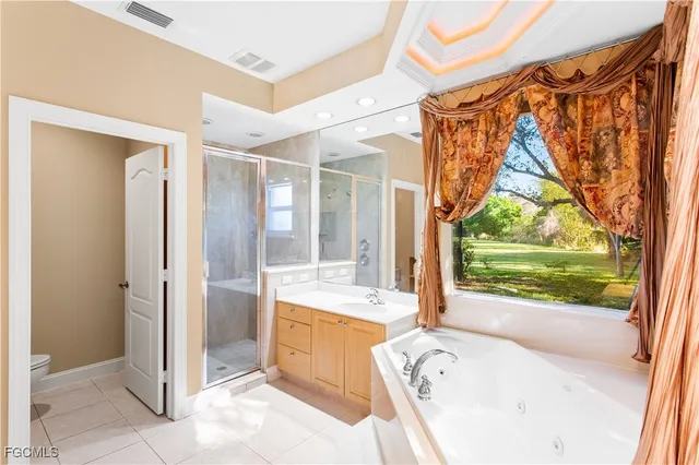 a bathroom with a tub sink and mirror