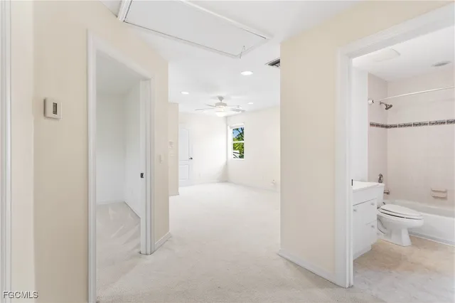 a bathroom with a granite countertop sink mirror and a toilet
