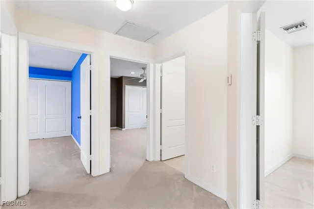 a view of a hallway with wooden shelves