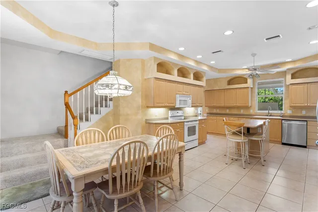 a dinning area with kitchen view and a chandelier