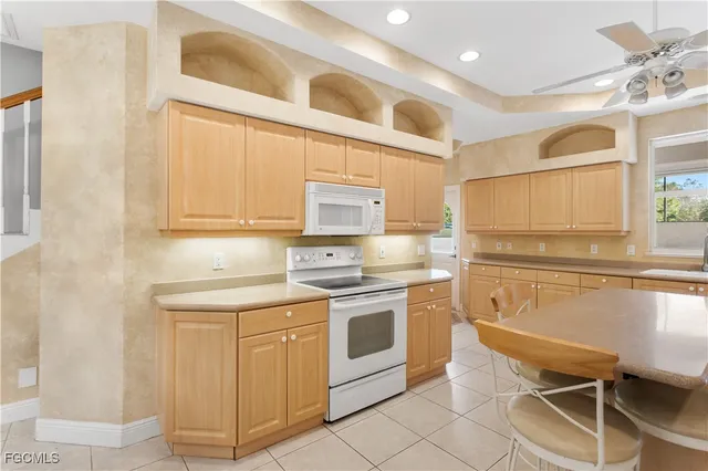 a kitchen with a stove sink and cabinets