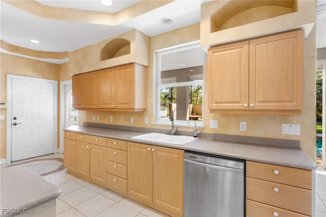 a kitchen with granite countertop white cabinets and a sink