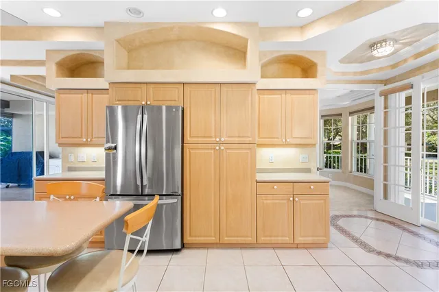a view of a kitchen with a table and chairs in it