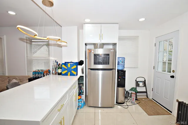 a kitchen with a refrigerator a stove and a sink