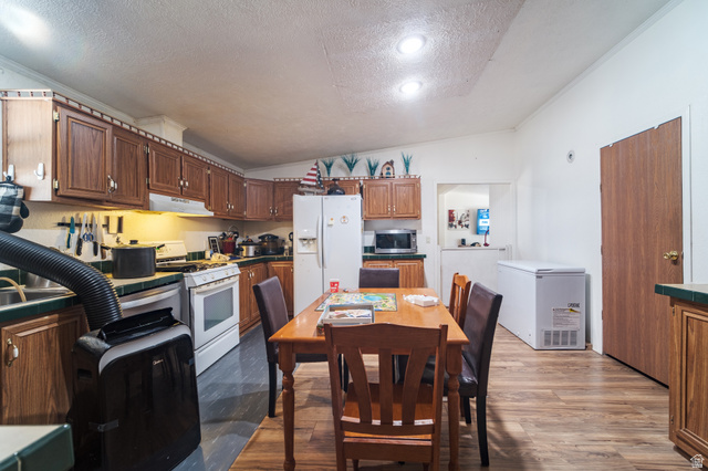 445 South Main Street Fayette, UT 84630 - Photo 34 of 45 Kitchen with white appliances, light wood-style floors, wood finish cabinetry, and ornamental molding
