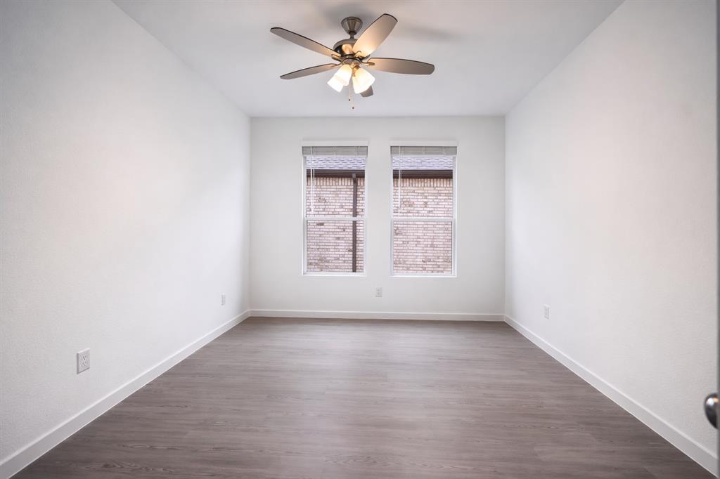 3017 Dutch Road Providence Village, TX 76227 - Photo 16 of 32 Spare room with dark wood-style floors and a ceiling fan