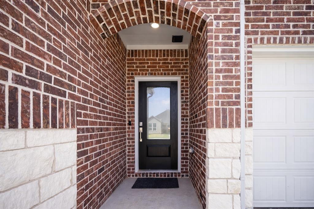 3017 Dutch Road Providence Village, TX 76227 - Photo 2 of 32 Entrance to property featuring brick siding and a garage