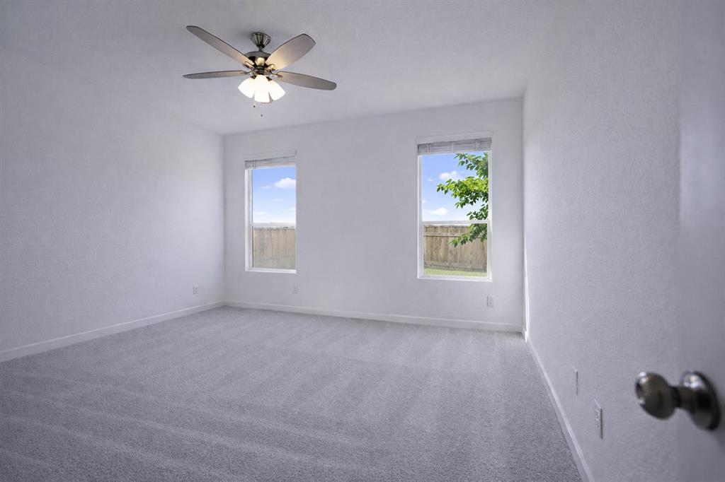 3017 Dutch Road Providence Village, TX 76227 - Photo 18 of 32 Unfurnished room featuring light carpet, plenty of natural light, and ceiling fan