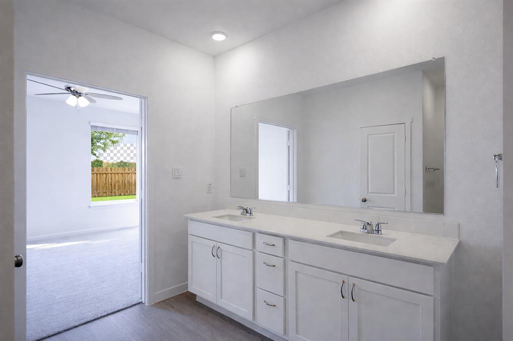 3017 Dutch Road Providence Village, TX 76227 - Photo 19 of 32 Bathroom featuring double vanity, dark wood-style floors, and a ceiling fan