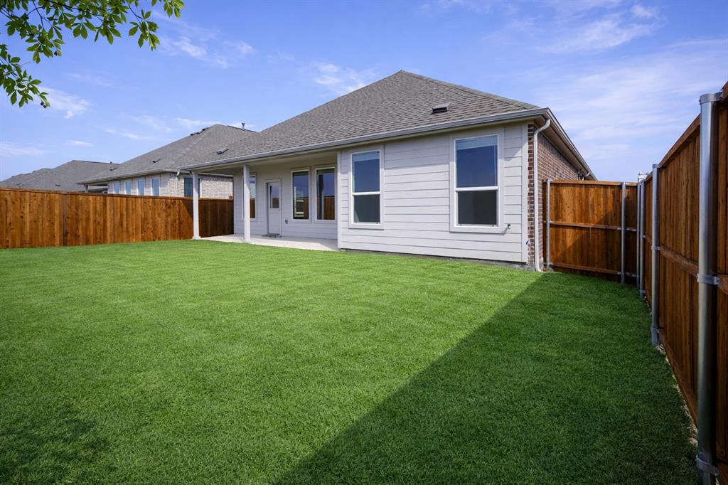 3017 Dutch Road Providence Village, TX 76227 - Photo 22 of 32 Rear view of property with a patio area, a fenced backyard, a shingled roof, and brick siding