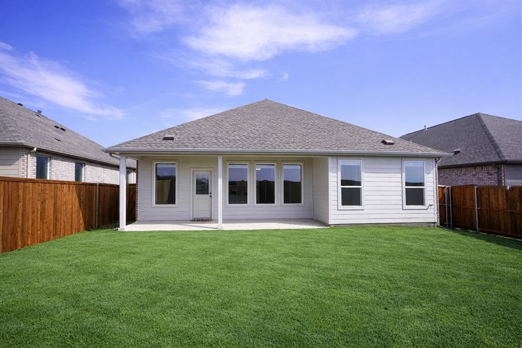 3017 Dutch Road Providence Village, TX 76227 - Photo 23 of 32 Back of property featuring a patio area, a fenced backyard, and a shingled roof