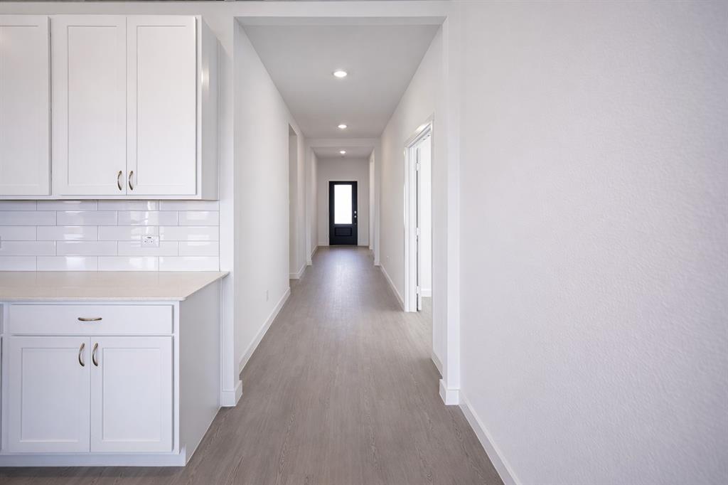 3017 Dutch Road Providence Village, TX 76227 - Photo 24 of 32 Corridor with recessed lighting and dark wood finished floors