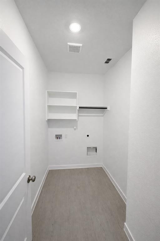 3017 Dutch Road Providence Village, TX 76227 - Photo 25 of 32 Laundry area with washer hookup, light wood-type flooring, electric dryer hookup, and gas dryer hookup