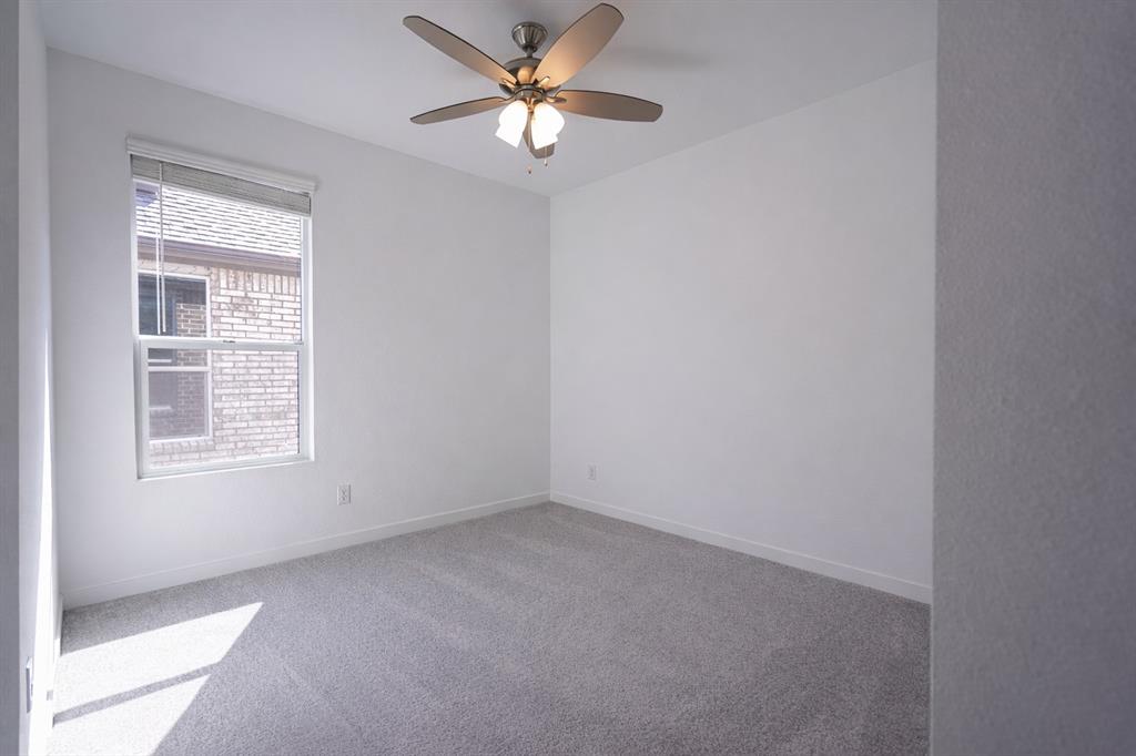 3017 Dutch Road Providence Village, TX 76227 - Photo 6 of 32 Spare room featuring carpet and ceiling fan