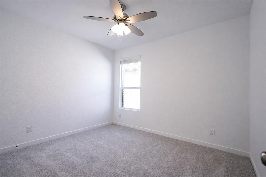 3017 Dutch Road Providence Village, TX 76227 - Photo 7 of 32 Unfurnished room with light carpet and ceiling fan
