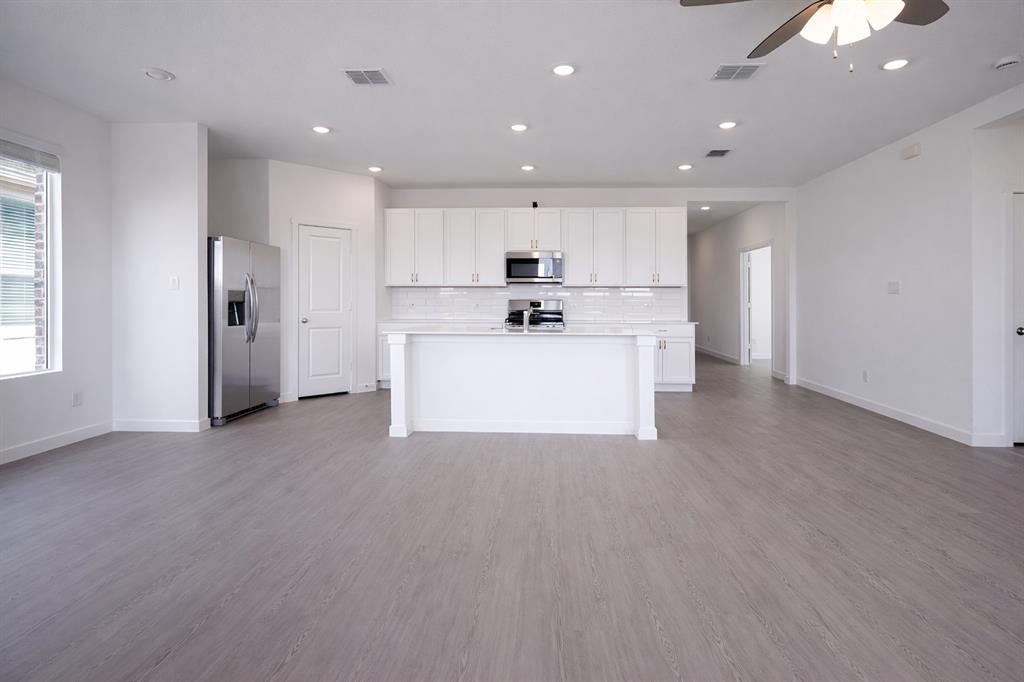 3017 Dutch Road Providence Village, TX 76227 - Photo 30 of 32 Kitchen with open floor plan, white cabinets, stainless steel appliances, a ceiling fan, and recessed lighting