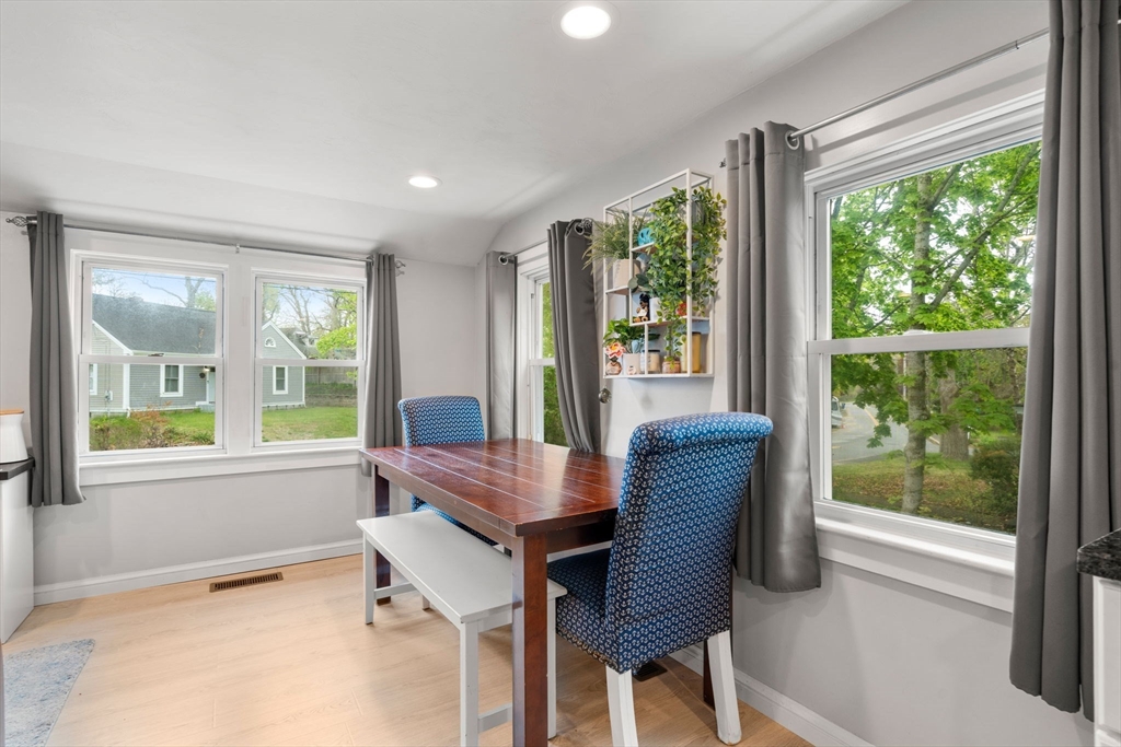 7 Indian Neck Road Wareham, MA 02571 - Photo 15 of 34 a dining room with furniture large windows and wooden floor