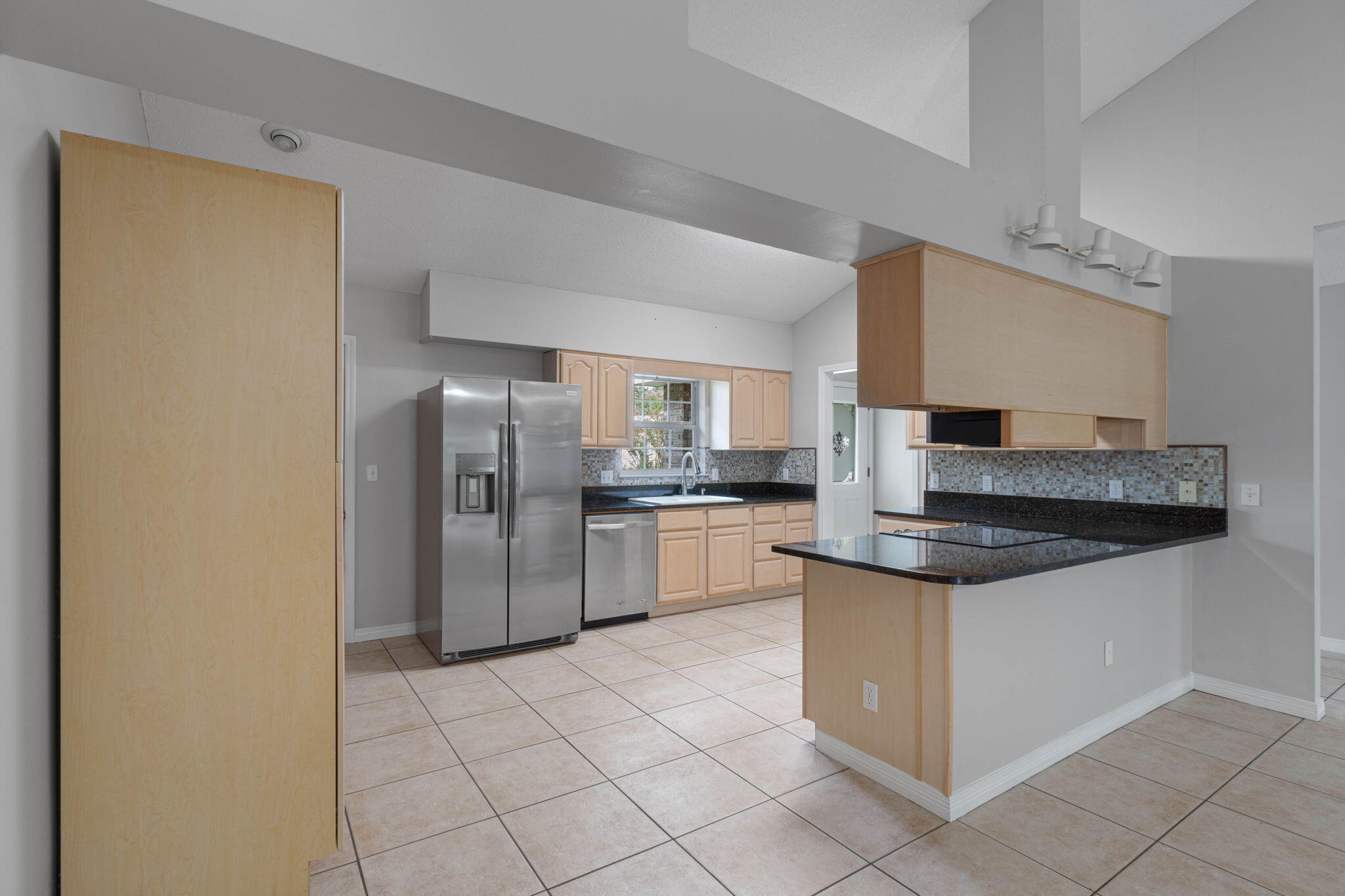 3816 Indigo Circle Destin, FL 32541 - Photo 11 of 36 a kitchen with stainless steel appliances granite countertop a refrigerator and a stove top oven