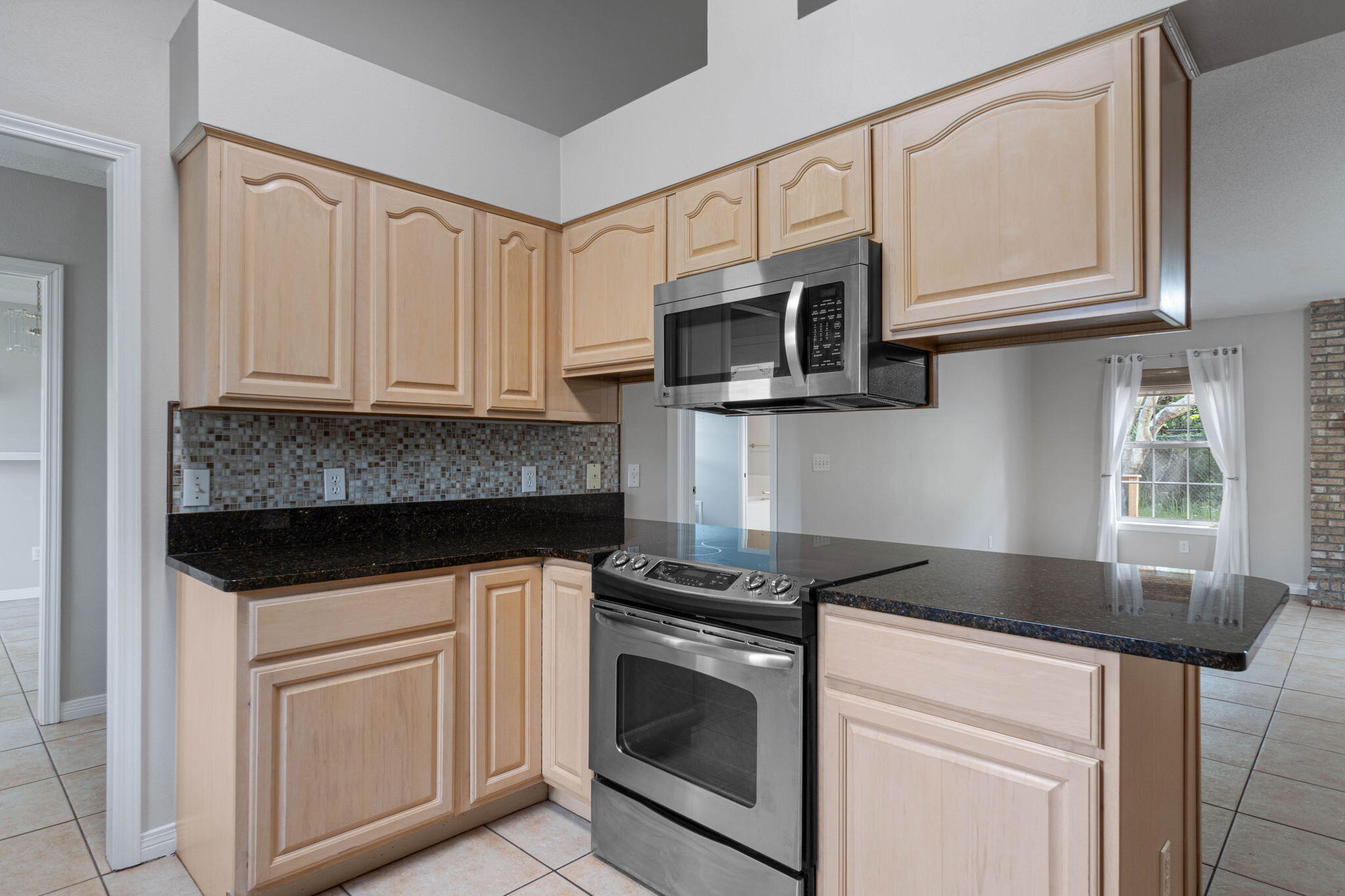 3816 Indigo Circle Destin, FL 32541 - Photo 12 of 36 a kitchen with granite countertop white cabinets stainless steel appliances and a sink