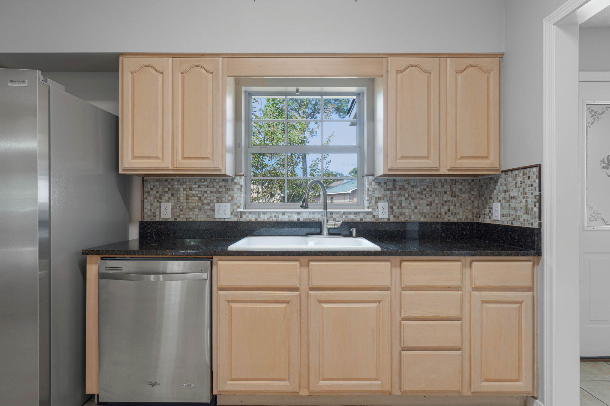 3816 Indigo Circle Destin, FL 32541 - Photo 13 of 36 a kitchen with white cabinets and white appliances