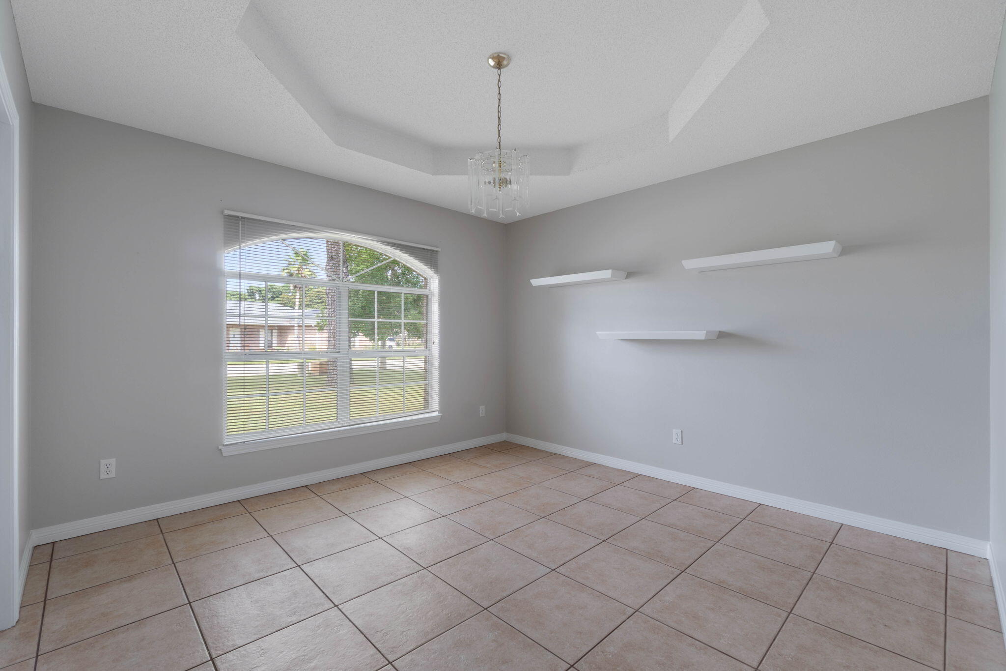 3816 Indigo Circle Destin, FL 32541 - Photo 15 of 36 an empty room with windows and ceiling fan