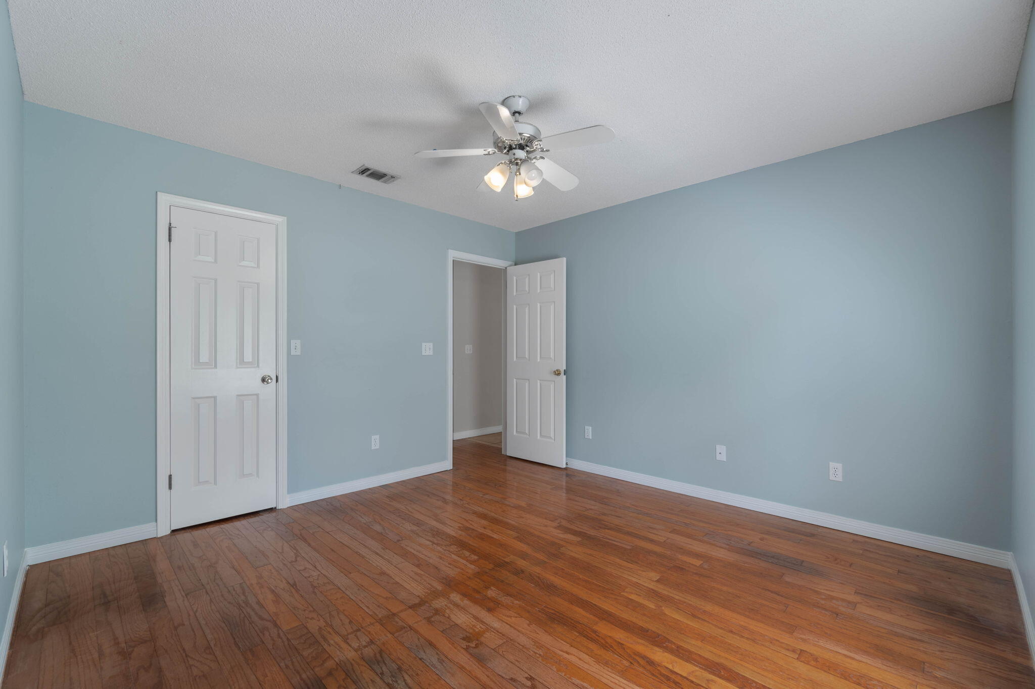 3816 Indigo Circle Destin, FL 32541 - Photo 17 of 36 a view of an empty room with wooden floor