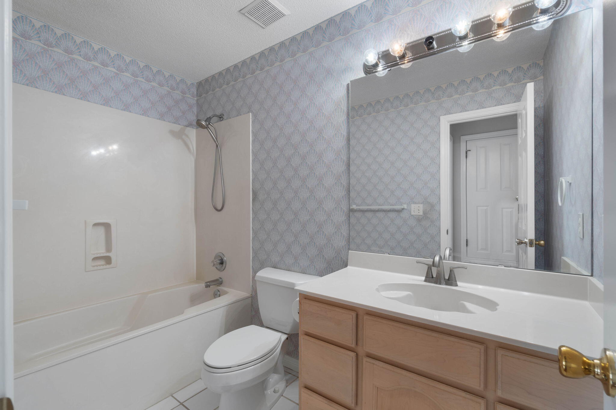 3816 Indigo Circle Destin, FL 32541 - Photo 19 of 36 a bathroom with a sink a toilet a mirror a vanity and shower