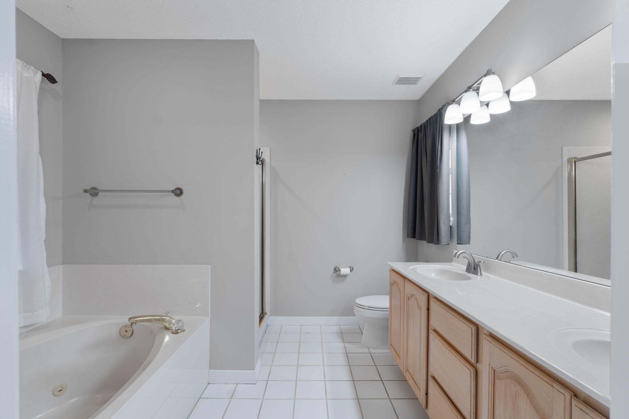 3816 Indigo Circle Destin, FL 32541 - Photo 26 of 36 a bathroom with a tub a sink and a mirror