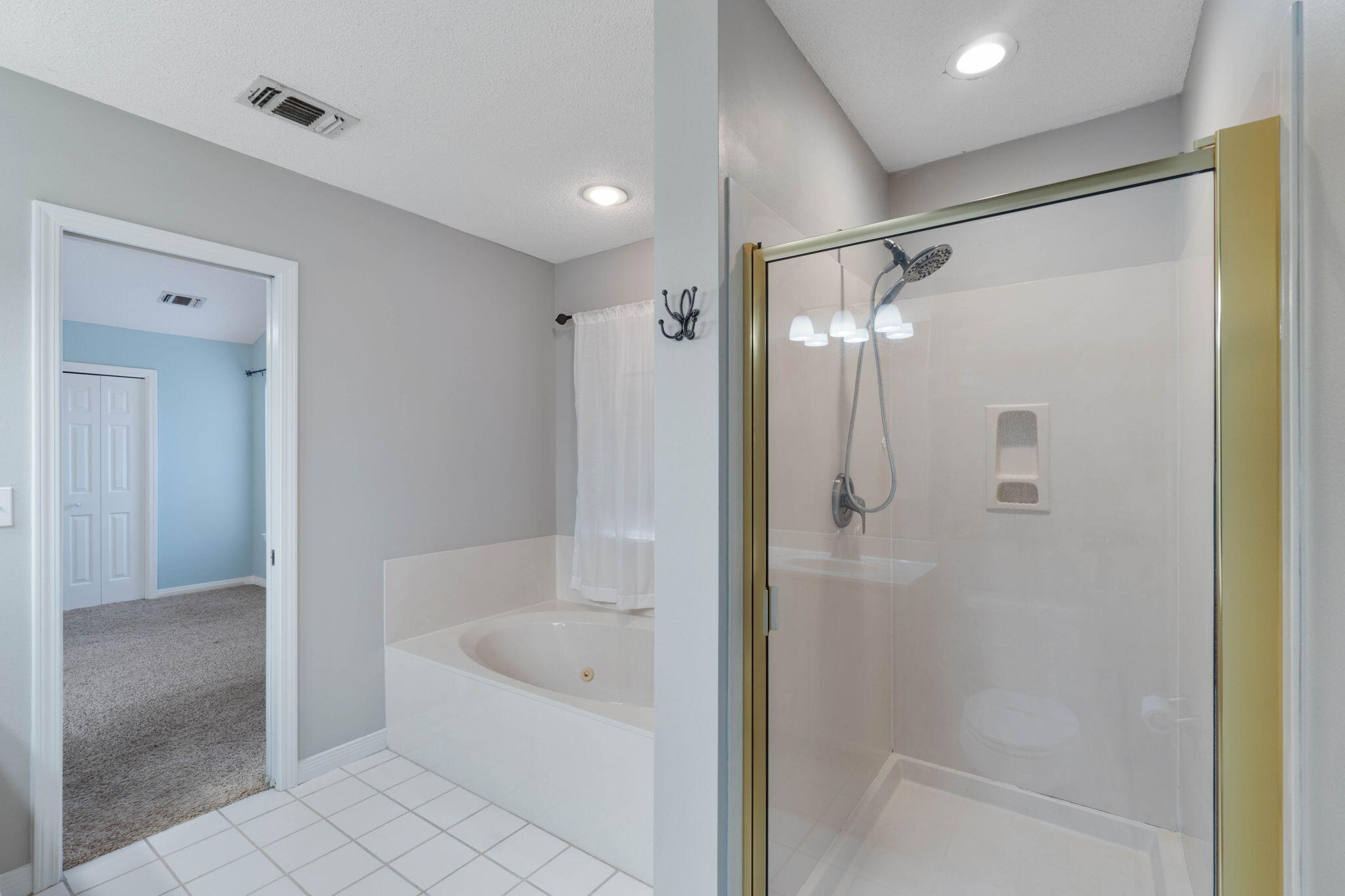 3816 Indigo Circle Destin, FL 32541 - Photo 28 of 36 a bathroom with a bathtub and a shower