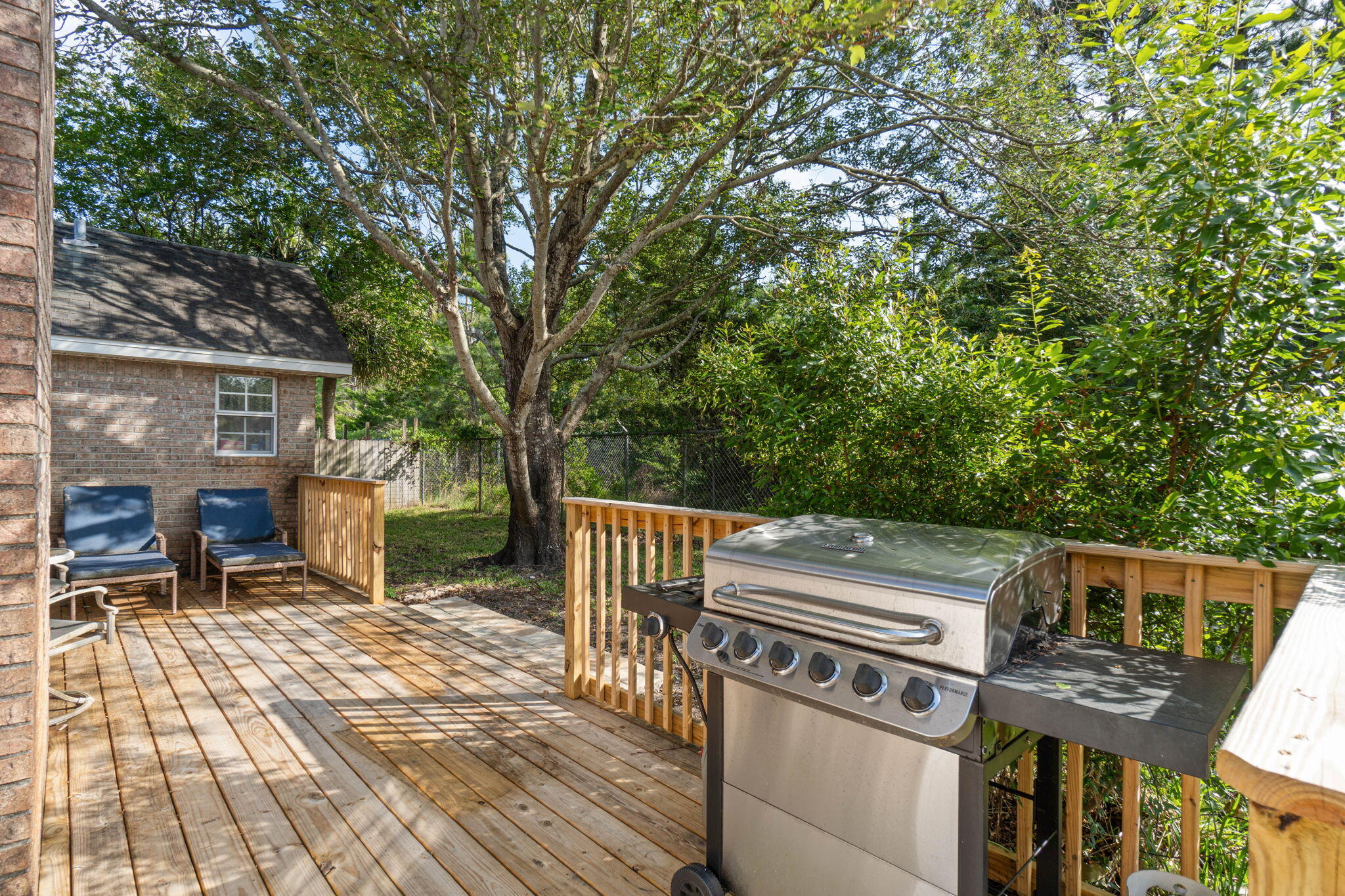 3816 Indigo Circle Destin, FL 32541 - Photo 34 of 36 a view of a patio with table and chairs and wooden floor