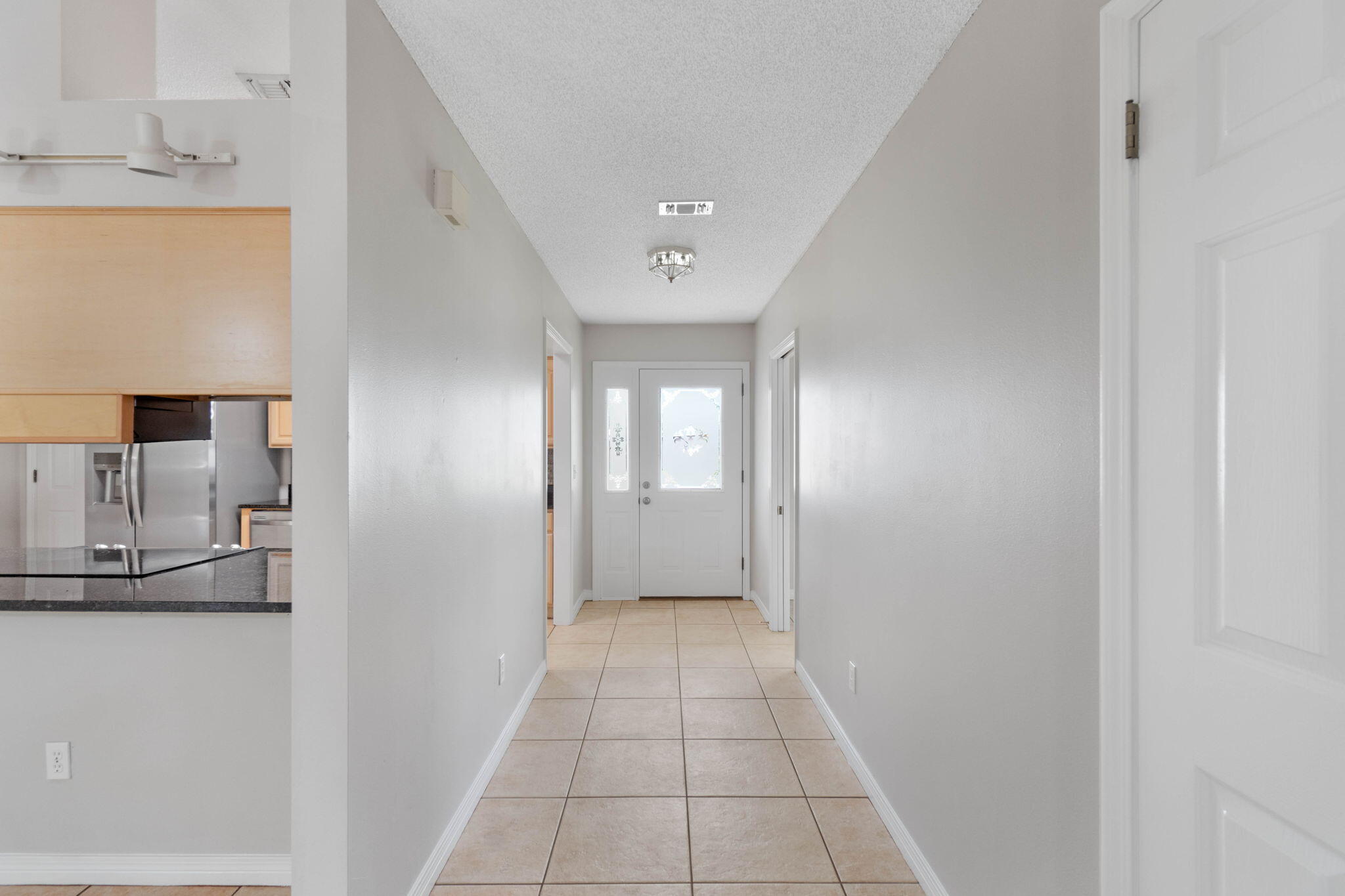 3816 Indigo Circle Destin, FL 32541 - Photo 5 of 36 a view of a hallway with a kitchen