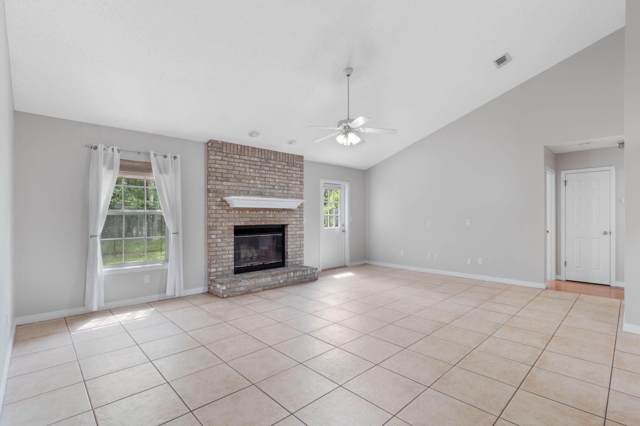 3816 Indigo Circle Destin, FL 32541 - Photo 6 of 36 a view of an empty room with a fireplace and a window
