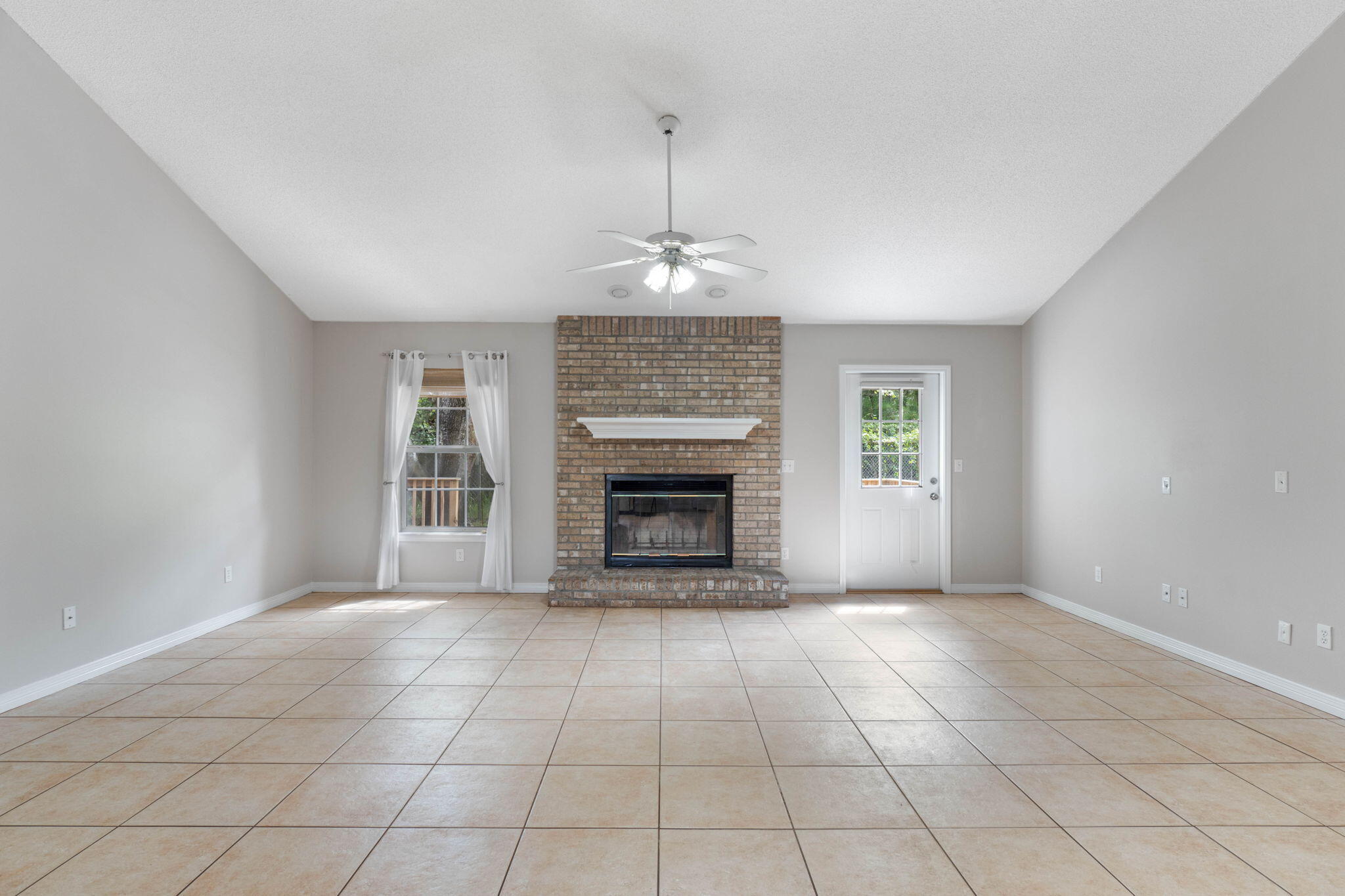 3816 Indigo Circle Destin, FL 32541 - Photo 7 of 36 a view of an empty room with a window and a fireplace