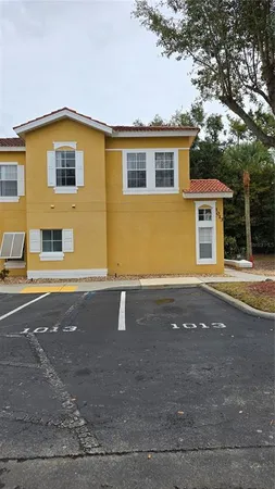 a view of a house with a yard and large windows