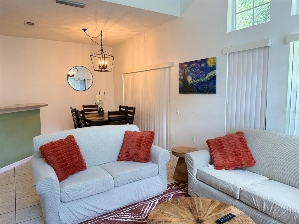1013 Park Ridge Circle Kissimmee, FL 34746 - Photo 12 of 74 a living room with furniture a rug and a window