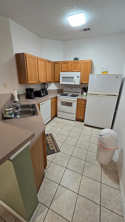 1013 Park Ridge Circle Kissimmee, FL 34746 - Photo 13 of 74 a kitchen with a sink a counter top space cabinets and stainless steel appliances